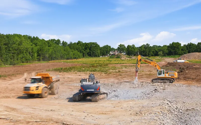 Overview of construction equipment during visible site-preparation work at South Coast on July 29, 2026
