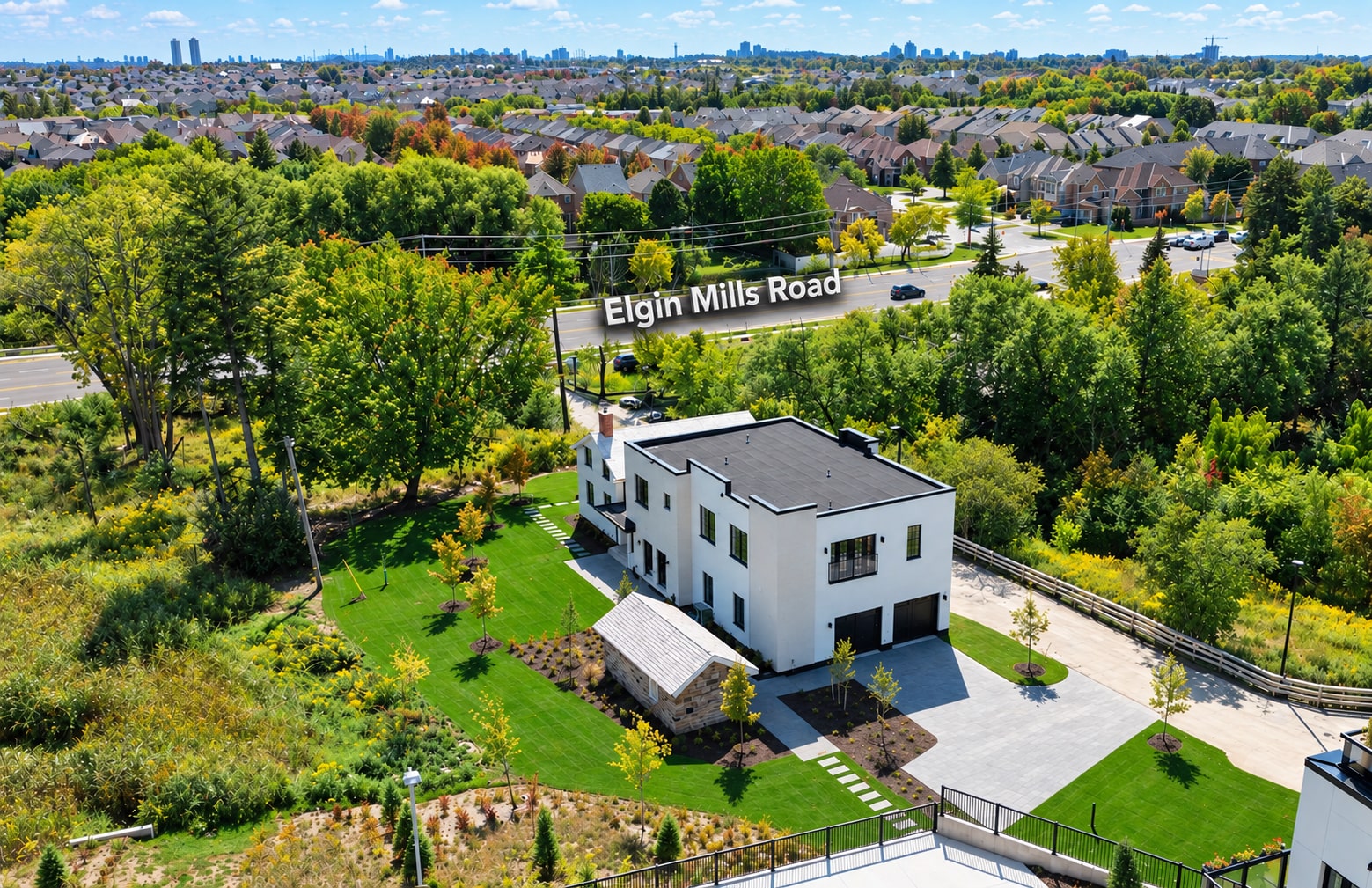Aerial view of a building and landscaped grounds beside Elgin Mills Road.